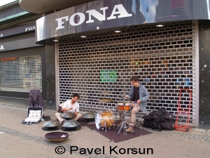 Уличные музыканты играют на инструментах - барабанах и хэнг драмах